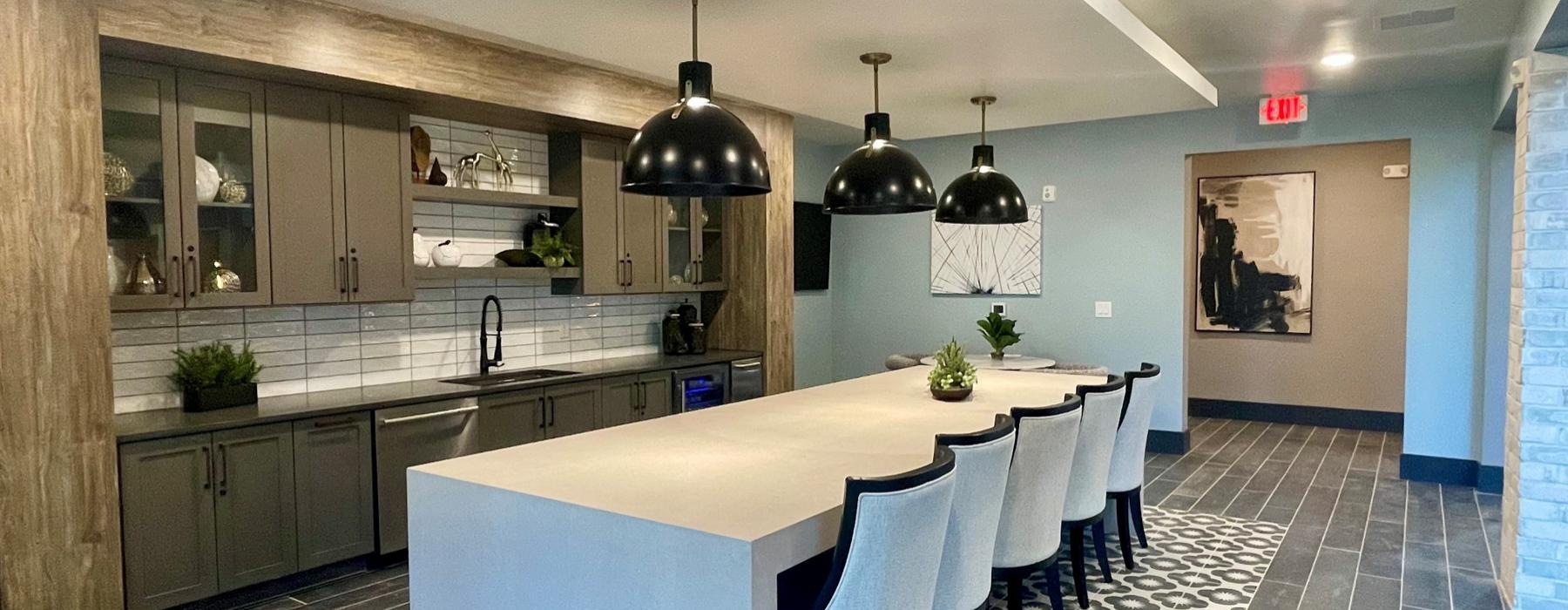 a kitchen with a large table and chairs