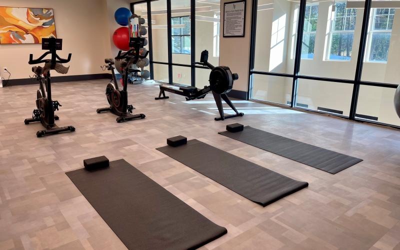 a gym with exercise equipment and yoga mats
