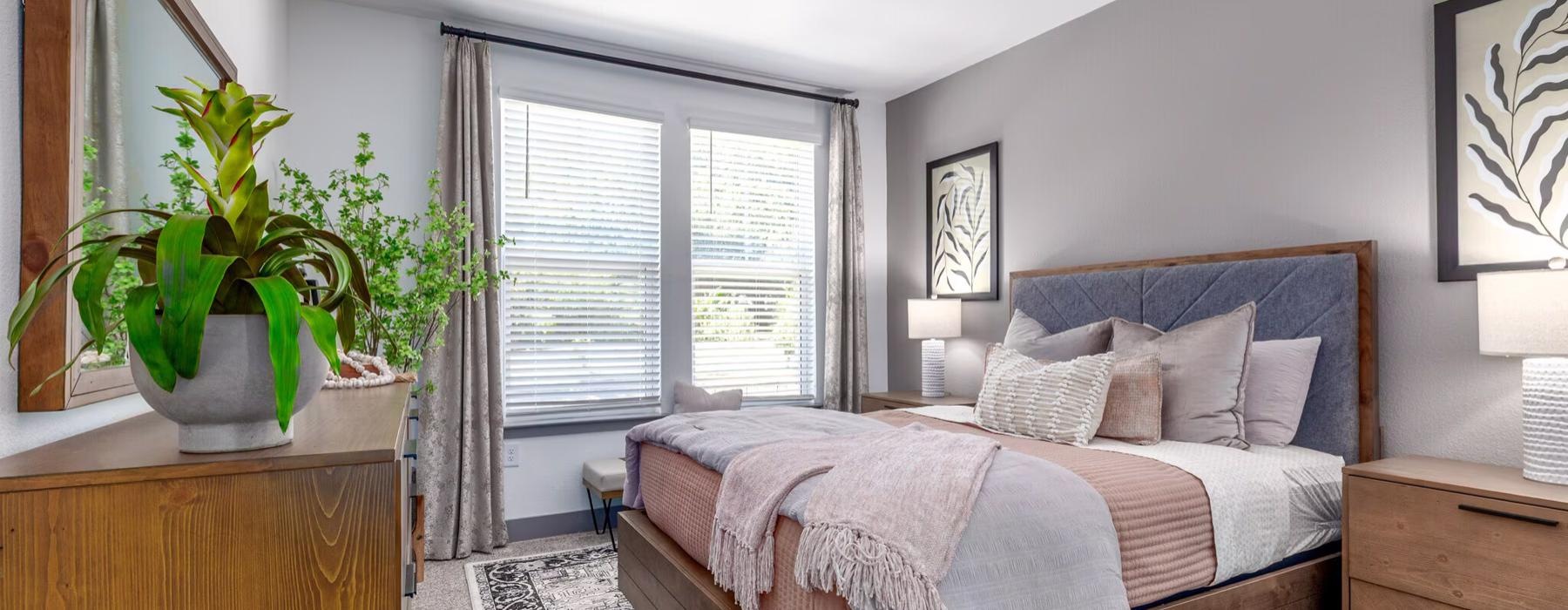 a bedroom with a bed and a plant