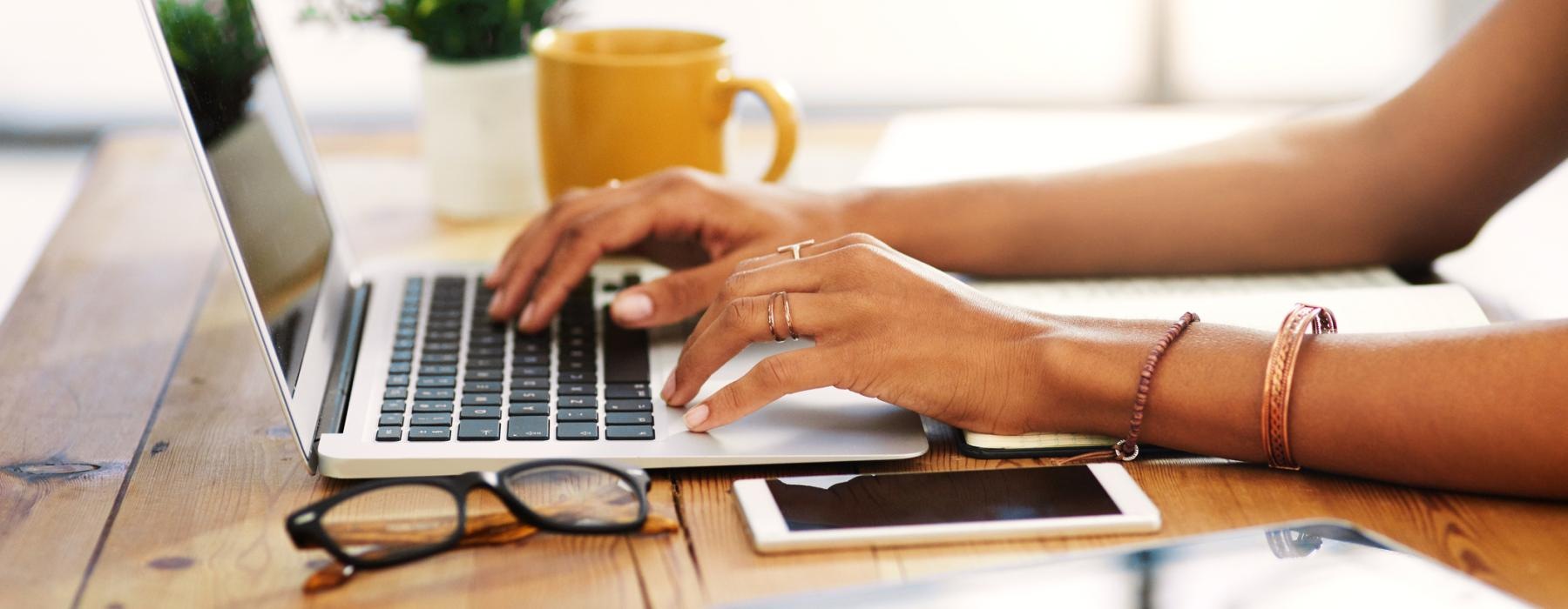a person typing on a laptop
