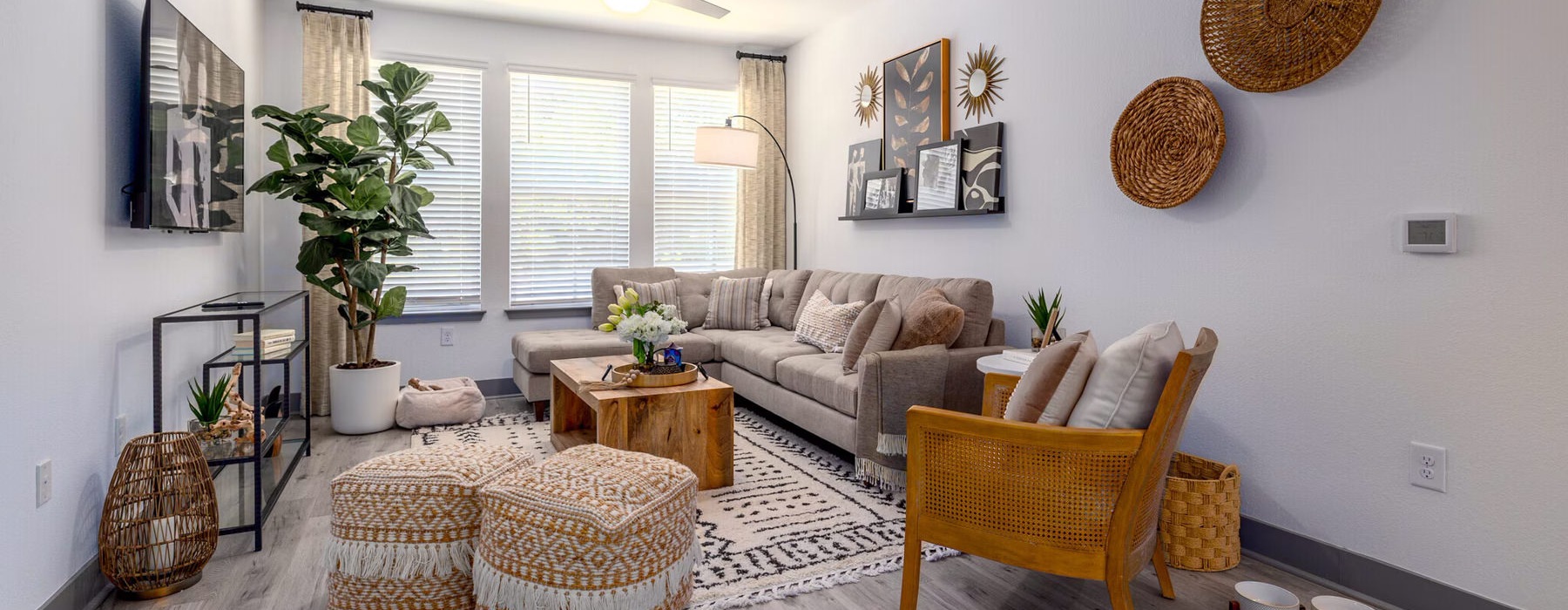 a living room with a tv seating and table